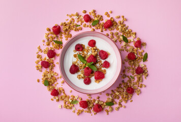 Bowl with greek yogurt, raspberries and granola. Top view flat lay. Healthy snack and nutrition breakfast.