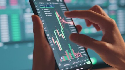 Closeup - Woman is checking Bitcoin price chart on digital exchange on smartphone, cryptocurrency future price action prediction.