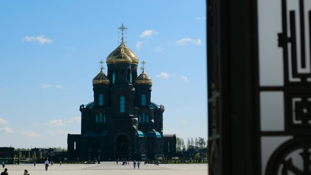 Kubinka, Russia - CIRCA 2021: Orthodox Church or tample in black color with golden domes, general form. smooth camera movement, faith in God and Christ. Cathedral in Park Patriot.