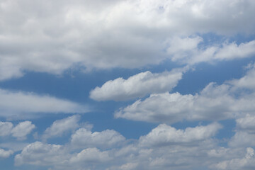 White fluffy clouds with blue sky on sunny day, beautiful summer cloudy sky background.