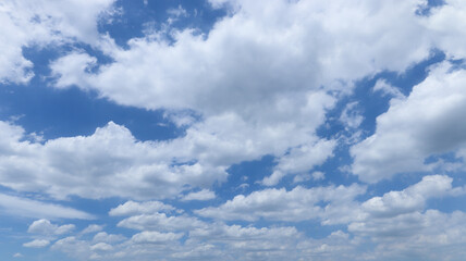 White fluffy clouds with blue sky on sunny day, beautiful summer cloudy sky background.