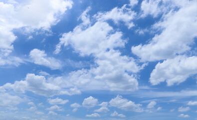 White fluffy clouds with blue sky on sunny day, beautiful summer cloudy sky background.