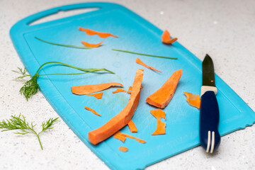 Obraz premium cutting board with leftover vegetables and a knife