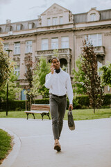 Young African American businessman using a mobile phone on a street