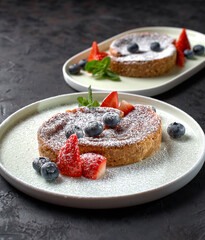 Crack Pie, American dessert with a rich salty-sweet taste on an oatmeal basis, on a black stone background.