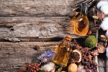 Witchcraft concept background with copy space. Witch doctor. Magic potions and dried plant on the wooden table.