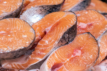 Fresh fish counter in the market. Laid out on ice salmon steaks. Natural products, proper nutrition, fish diet, local food. Open counter at the seafood market.