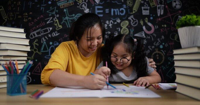 Happily young mother and little daughter drawing and paint together