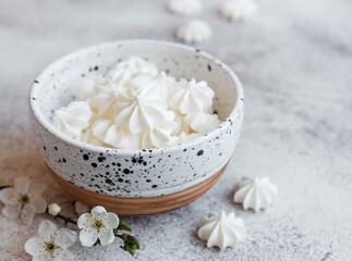 Small white meringues in the  ceramic bowl