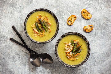 Homemade asparagus cream soup with croutons.