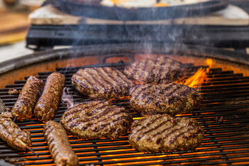 Prepared meat cutlet for burger on grill, closeup