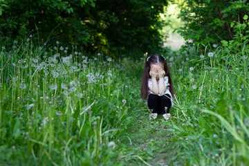 Obraz na płótnie Canvas The child was lost in the forest. Little girl alone in the forest. Child got lost and crying