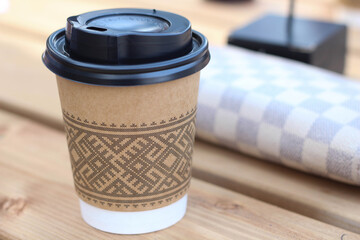 Take away brown Paper cup coffee on table. Cafe in Summer. Outside eating. 