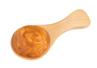 vegetable puree in a special wooden spoon for sauces isolated on white. The entire image is sharpness.