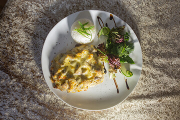 mushroom casserole with rice and herbs on a white plate
