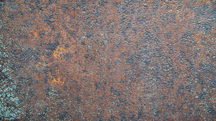 Rusty background. Old rusty metal surface with paint residues. Rusty metal texture. Natural creative texture for editing and design.