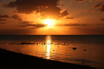 Orange sky above sea from Florida Keys island, US