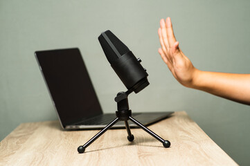 hand action with a microphone and laptop podcast