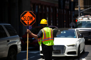 view of a construction worker  stopping traffic