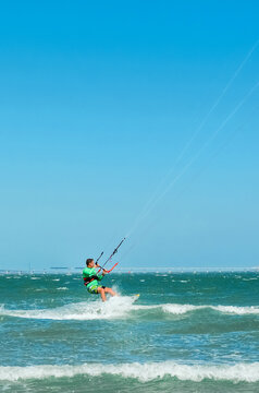Kite surfing on the blue sea in the background of blue sky at summer time. Kiteboarding. Fun in the ocean. Extreme Sport , surfing man