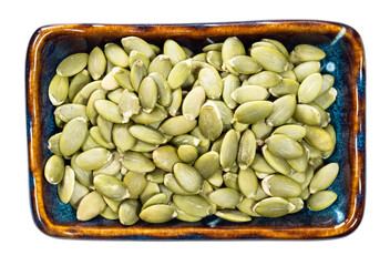 peeled pumpkin seeds in bowl cutout on white