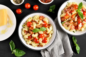 Pasta with bacon, tomato, parmesan cheese and basil leaves