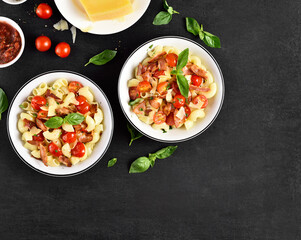 Pasta with bacon, tomato, parmesan cheese and basil leaves