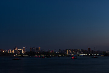 Fototapeta premium Night view of the city on the background of the river 
