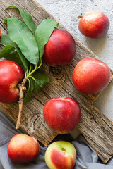 Ripe fresh nectarines on white stone background, healthy organic food, summer fruit