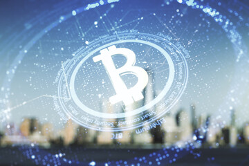 Virtual Bitcoin hologram on blurry skyline background. Multiexposure