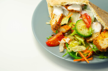 Mediterranean style pitta prepared with spicy chicken, cucumber, tomato, salad and mayo sauce