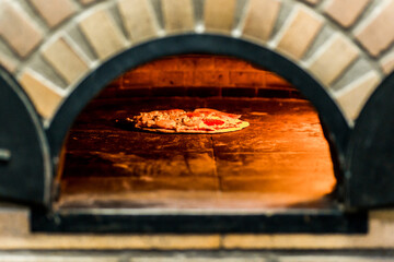 Pizzaiolo Preparing Artisan Pizza Cooking in Oven Heat Fire