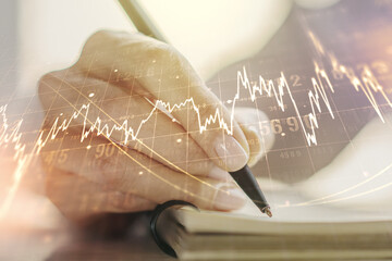 Abstract creative financial graph with hand writing in diary on background, financial and trading...