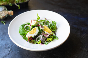 egg salad vegetables fresh green leaves mix spinach, arugula, lettuce, eggs boiled organic food healthy meal snack copy space food background top view veggie vegetarian keto or paleo diet