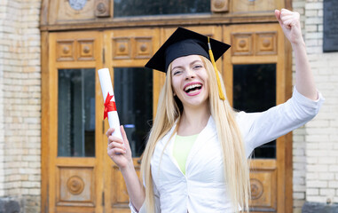 Success, graduation day! Get a university diploma. Portrait of a young happy woman student graduate in an academic cap.