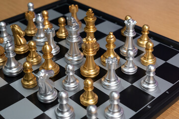 Chess board game to represent the business strategy with competition in the world market. and find out the best solution to meet target objective and goal. Sign and symbol of challenging as concept.	

