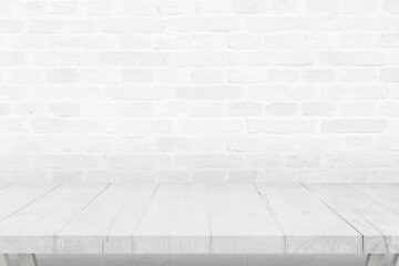 Empty white wooden desk and brick wall in background
