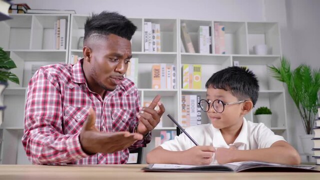 Angry African teacher and naughty student in a private class at home. A boy having lazy behavior, teacher upset a boy and complain. Studying at home. Learning during quarantine