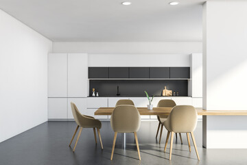 White kitchen interior with table and beige chairs, concrete floor