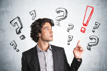 Young handsome businessman in black suit with confusion look poi