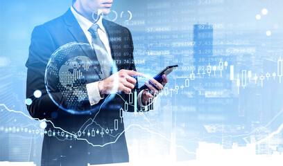 Businessman with phone in hands touch screen, earth globe and candlesticks