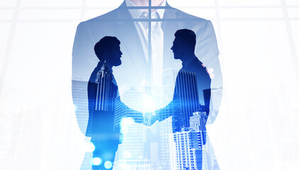 Businessmen shaking hands with a having a deal inside an meeting room with panoramic windows....