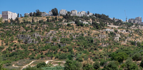 Fototapeta na wymiar A view of depopulated Palestinian Arab village Lifta on the western outskirts of Jerusalem, in the background a view of Jerusalem. Nature reserve of Lifta