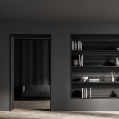 Dark living room interior with bookshelf and sofa behind door