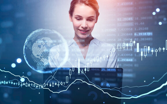 Businesswoman working with laptop, earth globe and candlesticks