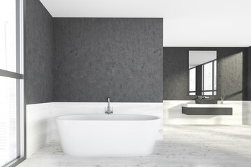 Naklejka na ściany i meble Modern design bathroom interior with white oval bathtub, black sink, countertop, silver faucets. Panoramic window with skyscrapers city view. Wooden and concrete materials.