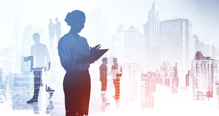 Business Woman check her notes in tablet device. Silhouettes of business partners, double exposure of people, New York skyscrapers on background. Concept of corporate business teamwork