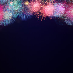 Fireworks explode at the top side. The copy space at below on dark background 2