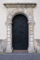 Fototapeta na wymiar Old steel door with decorative stone portal