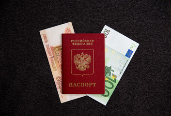 Russian passport, euros, five thousand rubles, flatlay. Currency exchange. Dark background